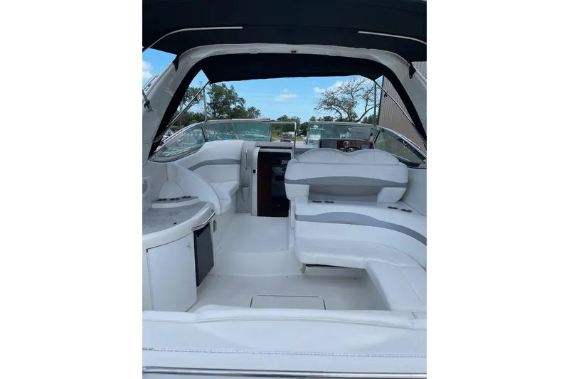 Slide: The Image of 2004 Formula 34 Performance Cruiser interior with white seating and helm view. - 10