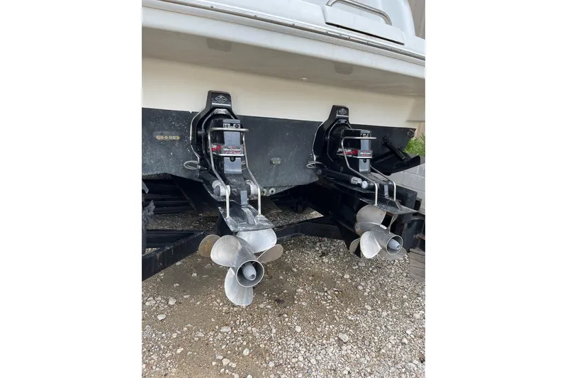 Slide: The Image of 2004 Formula 34 Performance Cruiser dual propellers on gravel surface. - 27