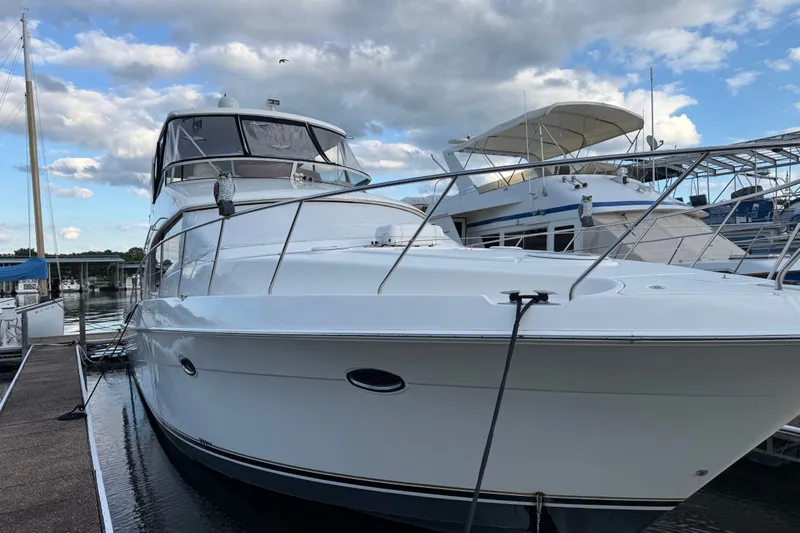 Slide: The Image of 2008 Silverton 52 Ovation yacht docked at marina under cloudy sky. - 1