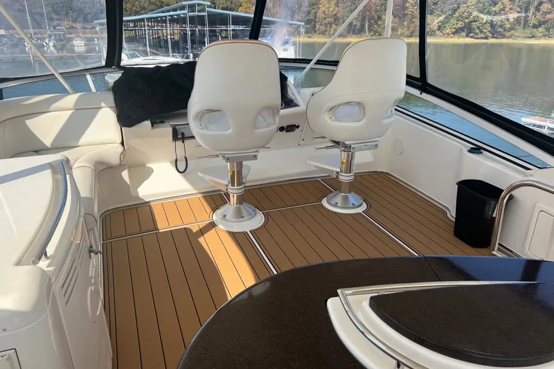 Slide: The Image of Interior of 2008 Silverton 52 Ovation yacht with white seating and wooden flooring. - 5