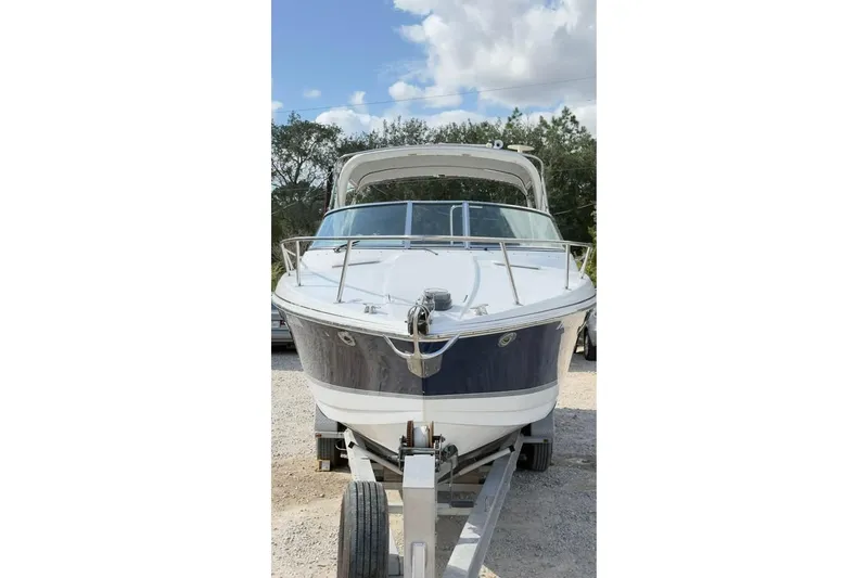Slide: The Image of 2005 Formula 330 Sun Sport boat on trailer under a cloudy sky. - 9