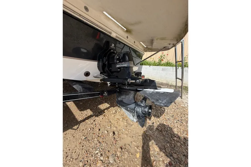Slide: The Image of 2009 Mastercraft X-45 boat with MerCruiser engine, displayed on gravel surface. - 22