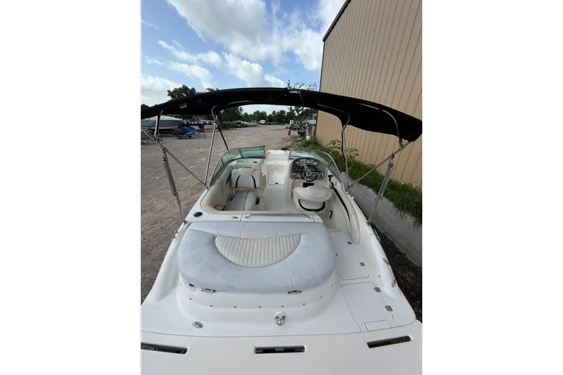 Slide: The Image of 2009 Mastercraft X-45 boat interior with seating and canopy, parked outdoors. - 18