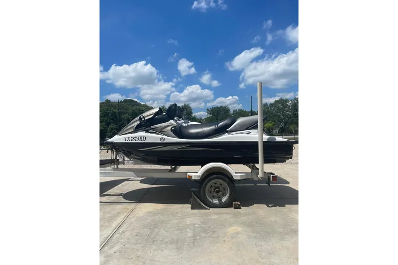 The Image of 2010 Kawasaki Jet Ski STX-15F on trailer under blue sky. - 1