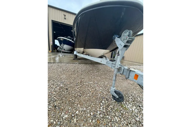 Slide: The Image of 2021 Bayliner Element F21 boat on trailer outside storage facility. - 6