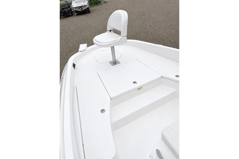 Slide: The Image of 2021 Bayliner Element F21 boat deck with white seating and storage compartments. - 12