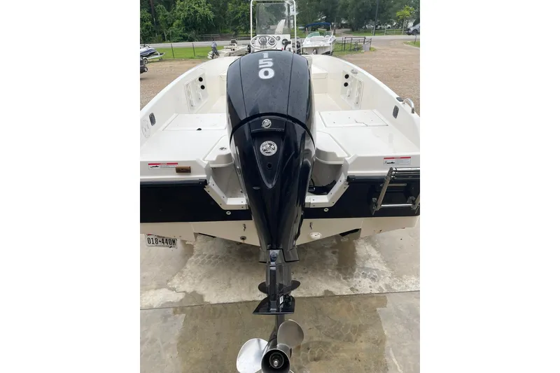 Slide: The Image of 2021 Bayliner Element F21 boat with outboard motor, parked on concrete. - 16