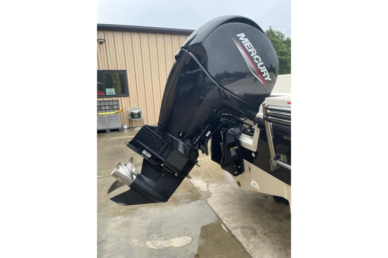 Slide: The Image of 2021 Bayliner Element F21 with Mercury outboard motor, parked on concrete surface. - 15