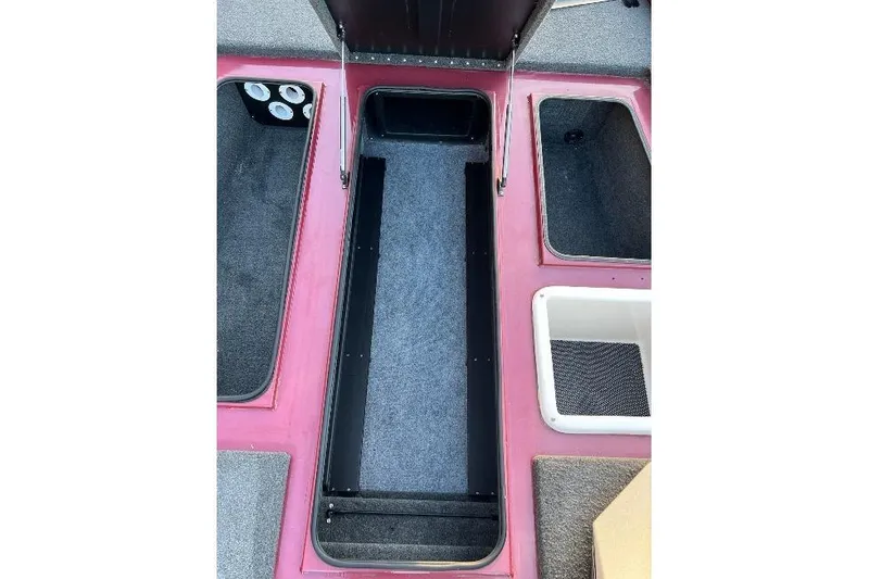 Slide: The Image of 2024 Avid 20 XB boat storage compartments with carpeted interiors and organized layout. - 23