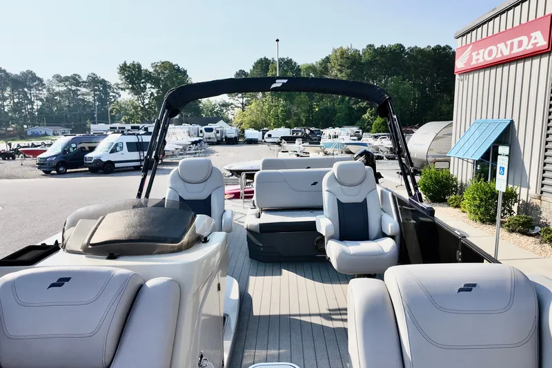 Slide: The Image of 2023 Starcraft CX 25 DL boat interior at dealership, featuring luxurious seating and modern design. - 6