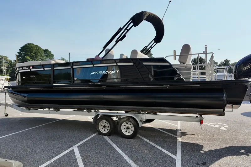 Slide: The Image of 2023 Starcraft CX 25 DL pontoon boat on trailer in parking lot. - 3