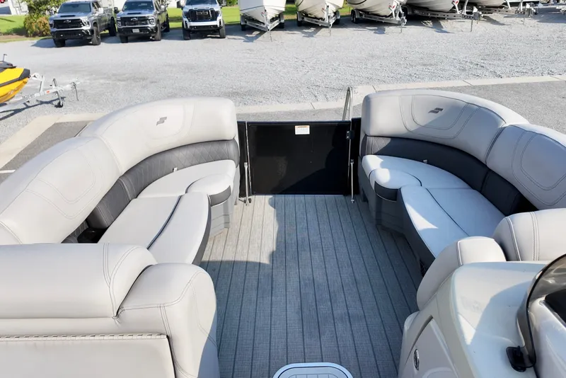 Slide: The Image of 2023 Starcraft CX 25 DL pontoon boat interior with plush seating and spacious deck. - 4