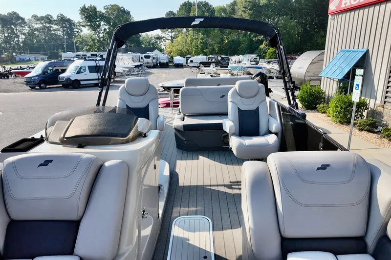 Slide: The Image of 2023 Starcraft CX 25 DL pontoon boat with luxurious seating, displayed outdoors. - 7