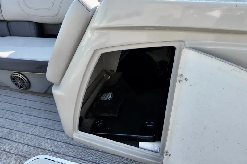 Slide: The Image of 2023 Starcraft CX 25 DL boat storage compartment with open hatch and seating area. - 13