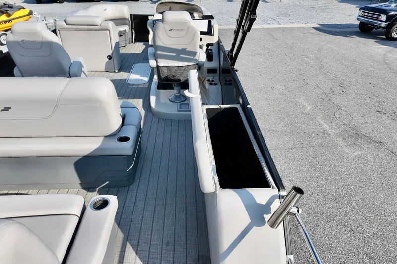 Slide: The Image of 2023 Starcraft CX 25 DL pontoon boat interior with gray seating and helm. - 8