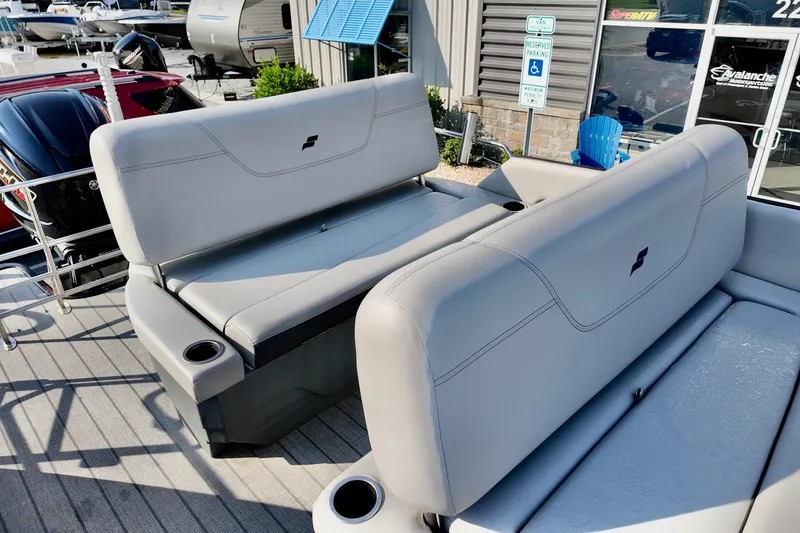 Slide: The Image of 2023 Starcraft CX 25 DL boat interior with gray seating and cup holders. - 10
