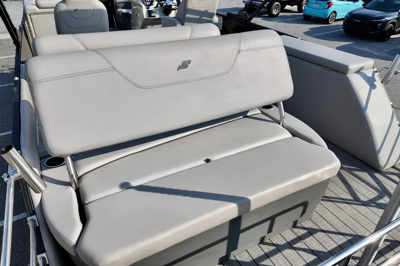 Slide: The Image of 2023 Starcraft CX 25 DL boat interior with gray seating and cup holders. - 11