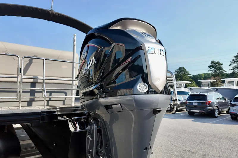 Slide: The Image of 2023 Starcraft CX 25 DL with Yamaha 200 outboard motor in a parking lot. - 15