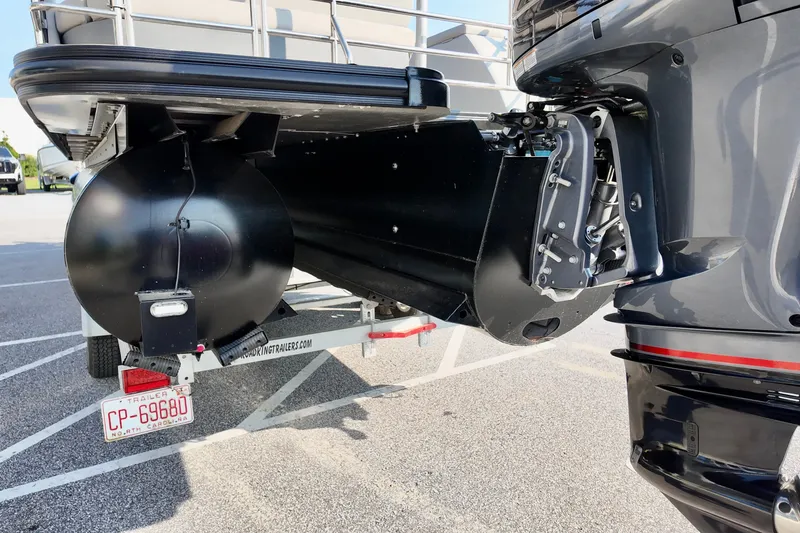 Slide: The Image of 2023 Starcraft CX 25 DL pontoon boat with trailer, featuring a visible outboard motor. - 16