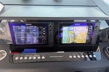 Slide: The Image of 2024 Axopar 37 Sun-Top dashboard with dual Simrad navigation displays. - 5