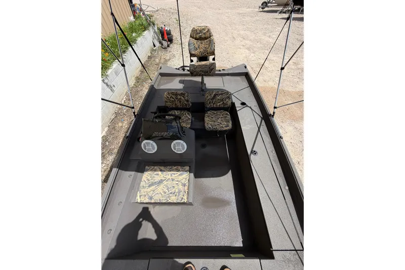 Slide: The Image of 2024 Alweld 1856 Invader boat interior with camo seats and console. - 8