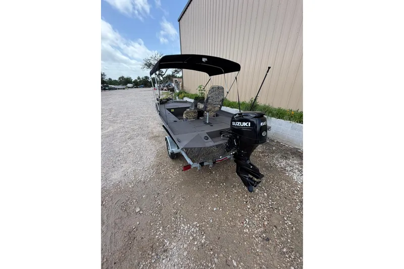 Slide: The Image of 2024 Alweld 1856 Invader boat with Suzuki 60 outboard motor on gravel. - 21