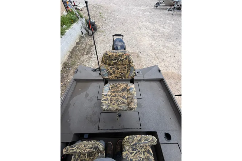 Slide: The Image of 2024 Alweld 1856 Invader boat interior with camouflage seats and spacious deck. - 16