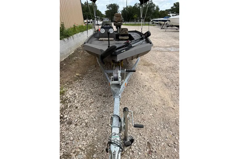 Slide: The Image of 2024 Alweld 1856 Invader boat on trailer, parked on gravel surface. - 3