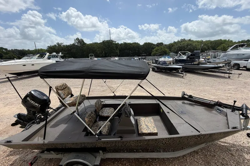 Slide: The Image of 2024 Alweld 1856 Invader boat with canopy and Suzuki motor in a marina. - 5