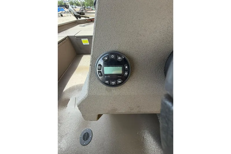 Slide: The Image of Control panel on 2024 Alweld 1856 Invader boat dashboard, featuring digital display and buttons. - 11
