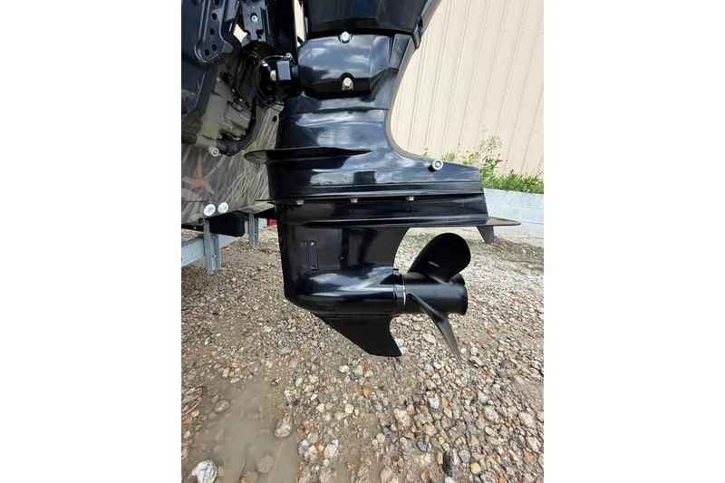 Slide: The Image of 2024 Alweld 1856 Invader boat motor and propeller on gravel surface. - 19