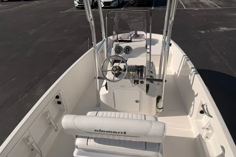 Slide: The Image of 2019 Bayliner Element F18 boat interior with steering console and seating. - 7