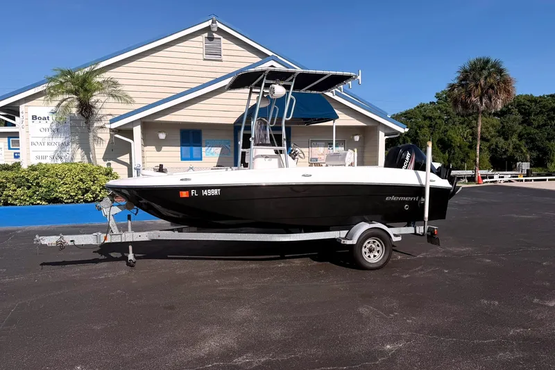 The Image of 2019 Bayliner Element F18 boat on trailer in front of rental office. - 0