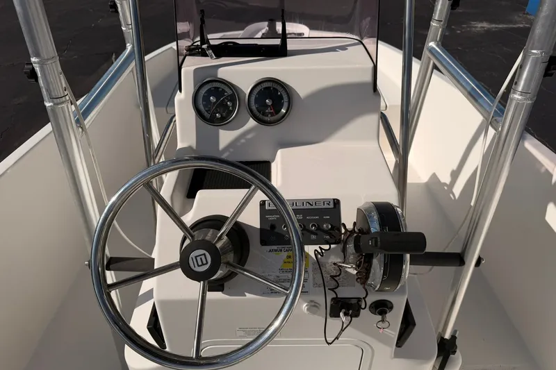 Slide: The Image of 2019 Bayliner Element F18 boat dashboard with steering wheel and gauges. - 8