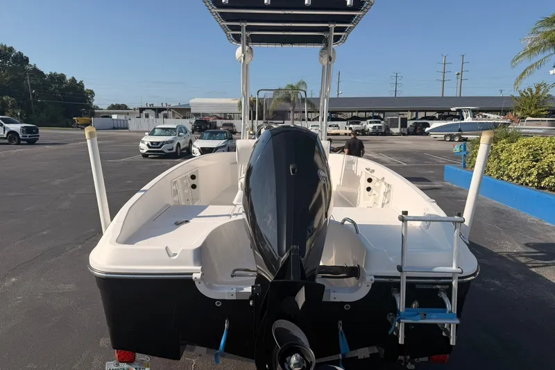 Slide: The Image of 2019 Bayliner Element F18 boat with outboard motor, parked in a lot under clear skies. - 6