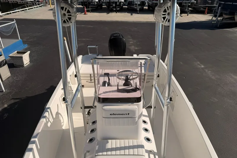 Slide: The Image of 2019 Bayliner Element F18 boat interior with steering console and seating. - 12