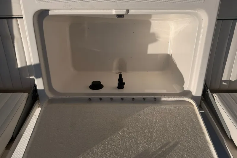 Slide: The Image of Open storage compartment on a 2019 Bayliner Element F18 boat. - 14