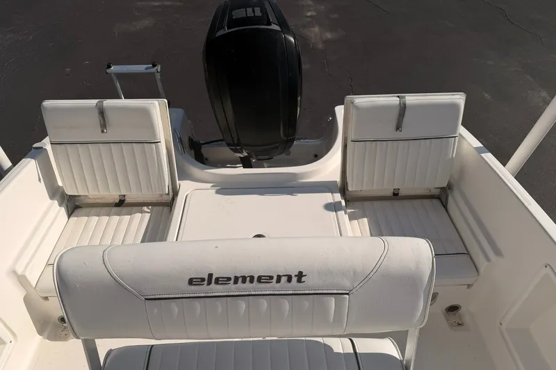 Slide: The Image of 2019 Bayliner Element F18 boat interior with white seating and motor. - 13