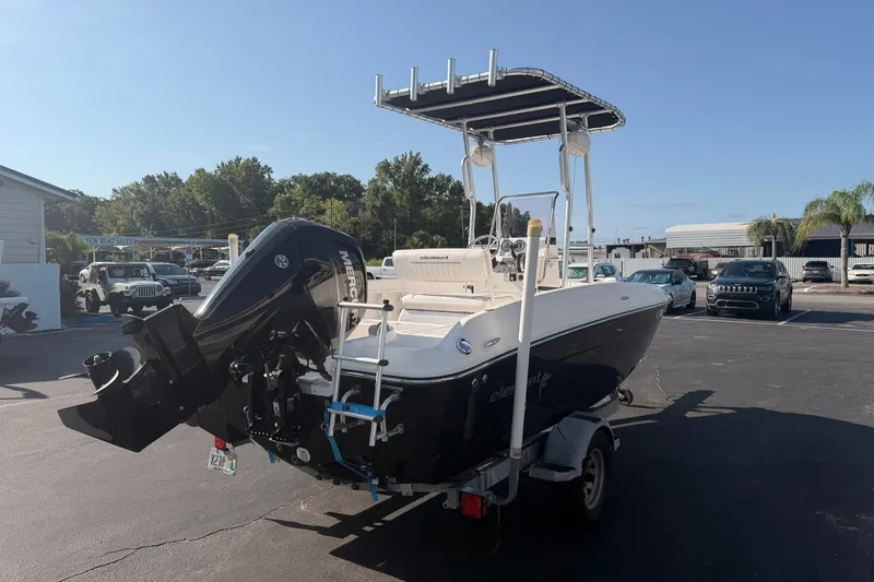 Slide: The Image of 2019 Bayliner Element F18 boat with outboard motor in a parking lot. - 5