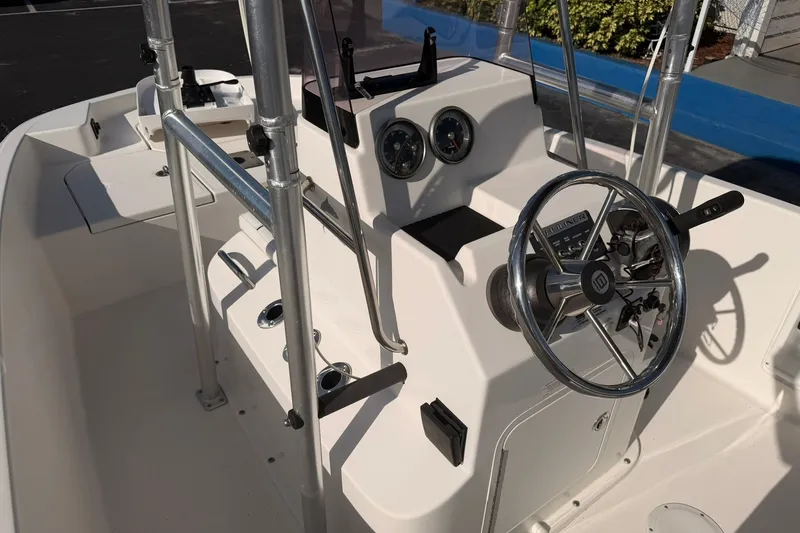 Slide: The Image of 2019 Bayliner Element F18 boat cockpit with steering wheel and control panel. - 9