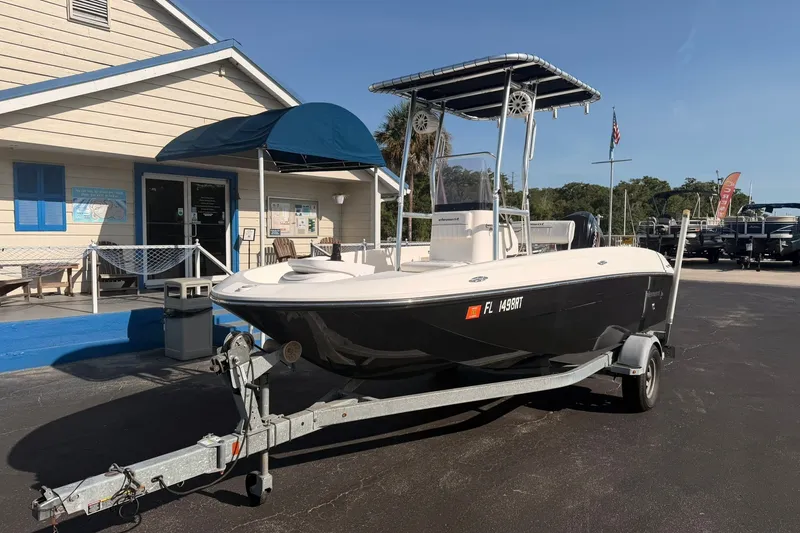 Slide: The Image of 2019 Bayliner Element F18 boat on trailer outside a building. - 1
