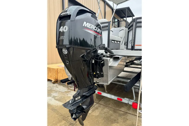 Slide: The Image of 2023 Crest 220 Classic LX with Mercury 40 HP outboard motor on a trailer. - 16