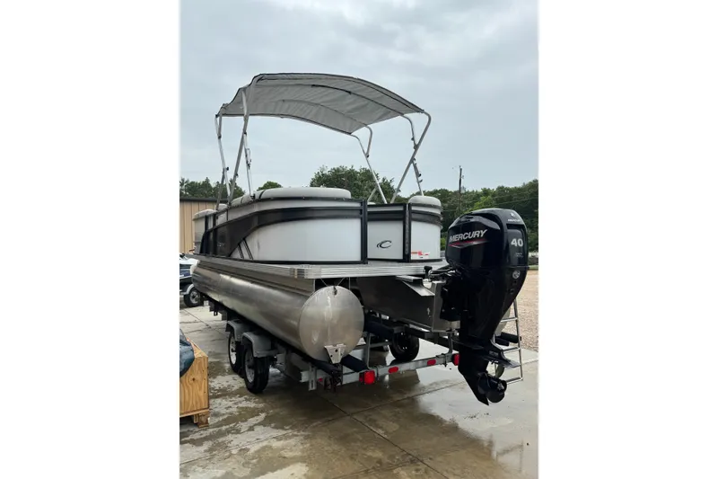 Slide: The Image of 2023 Crest 220 Classic LX pontoon boat with Mercury 40 engine on trailer. - 19