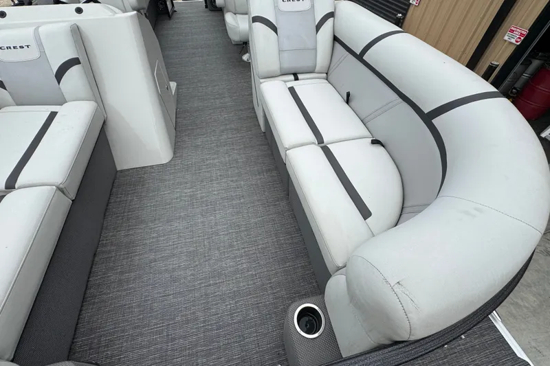 Slide: The Image of 2023 Crest 220 Classic LX pontoon boat interior with gray seating and flooring. - 14