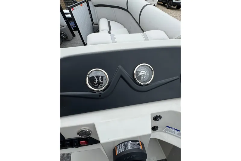 Slide: The Image of 2023 Crest 220 Classic LX boat dashboard with gauges and seating area. - 11