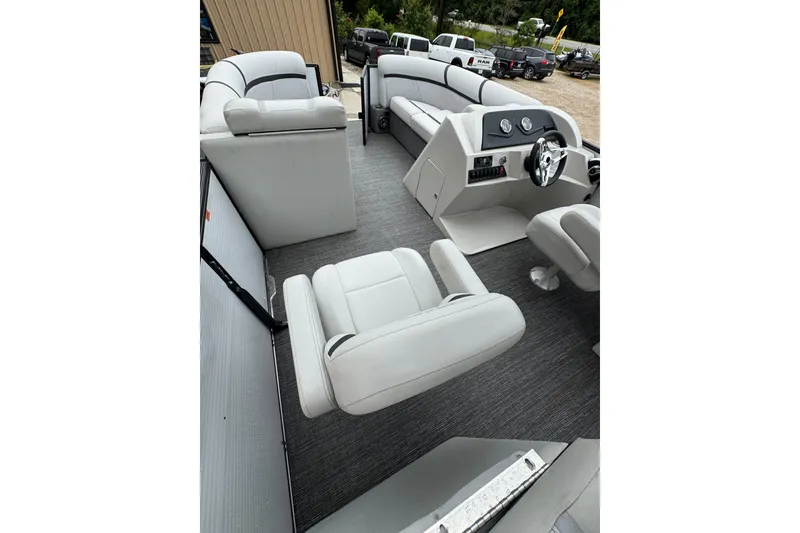 Slide: The Image of 2023 Crest 220 Classic LX pontoon boat interior with plush seating and modern dashboard. - 7