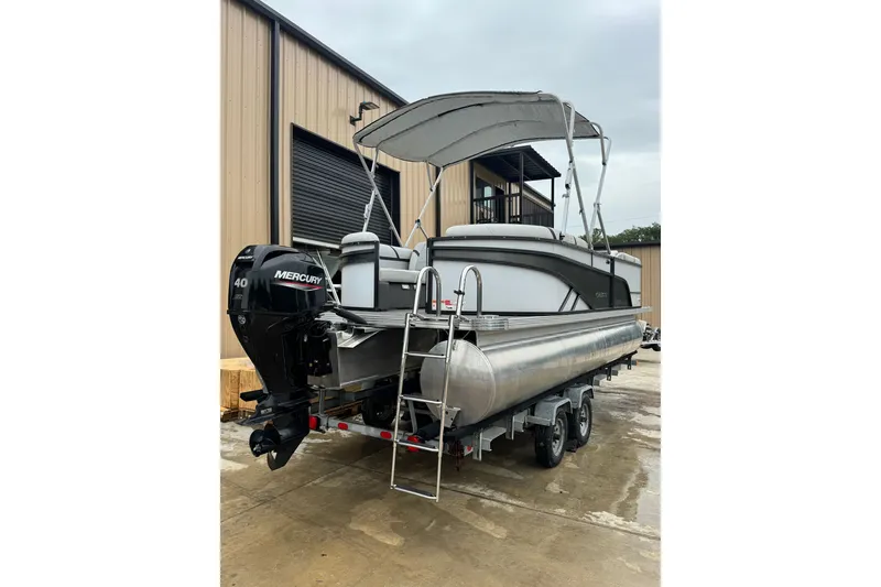 Slide: The Image of 2023 Crest 220 Classic LX pontoon boat with Mercury 40 engine, parked outside a warehouse. - 18