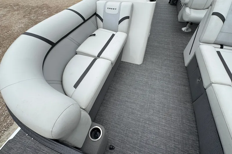 Slide: The Image of 2023 Crest 220 Classic LX boat interior with gray seating and flooring. - 13