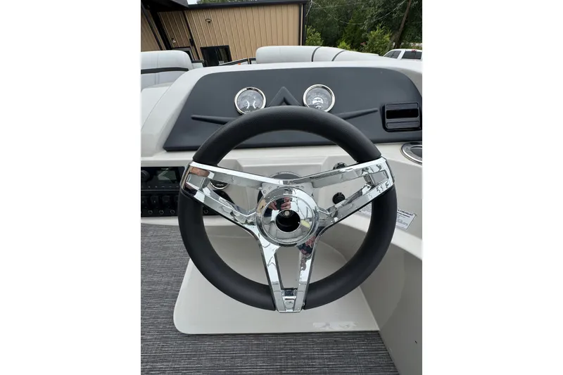 Slide: The Image of Steering wheel of 2023 Crest 220 Classic LX boat, featuring sleek chrome accents. - 10