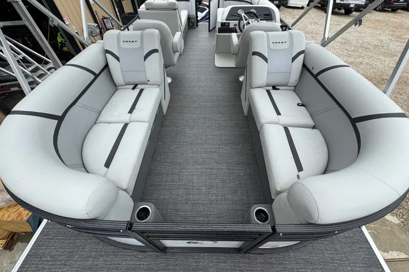 Slide: The Image of 2023 Crest 220 Classic LX pontoon boat interior with gray seating and modern design. - 5
